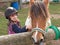 Child stroking Pony