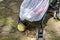 Child in stroller covered with protective net during walk. Baby carriage with anti-mosquito white cover. Midge