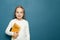 Child student girl with English British language book on the background of blue chalkboard