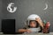 Child studies remotely at school, wearing an astronaut`s helmet. back to school