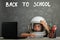 child studies remotely at school, wearing an astronaut`s helmet. back to school