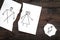 Child suffers from a divorce. Torn sheet of paper with drawn man, woman and child on dark wooden background top view