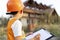 Child in a suit of an engineer is checking and inspecting the building or house before restoration, reconstruction or demolition.