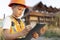 Child in a suit of an engineer is checking and inspecting the building or house before restoration, reconstruction or demolition.