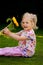 Child with sunflowers in the garden in summer