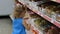 Child in the supermarket buys candies and sweets. Shopping store