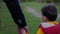 child support, male parent holds his beloved boy by hand during family walk on warm evening