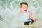 Child surfing on bodyboard at beach