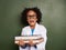 Child, surprise and portrait with books by chalkboard for education stress, science learning and physics knowledge