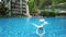 child swimming away from other in a beautiful swimming pool in the condominium, Singapore