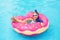 Child in swimming pool on donut float