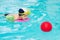 Child swimming pool, kid playing water ball, boy indoor training