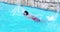 Child swimming with a red swimwear