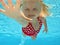 Child swimming underwater in pool
