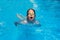 Child swims butterfly style in the pool