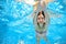 Child swims in pool underwater, girl has fun in water