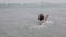 Child swims in the sea jumping on the waves