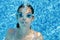 Child swims in swimming pool underwater, happy active teenager girl dives and has fun under water, kid fitness and sport