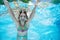 Child swims underwater in swimming pool, happy active teenager girl dives and has fun under water, kid fitness and sport