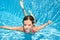 Child swims underwater in swimming pool, little active girl dives and has fun under water, kid fitness and sport