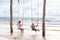 Child on swing. Kid swinging on beach