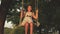 Child swinging on a swing in park in sun. young girl swinging on rope swing on an oak branch. teen girl enjoys flight on