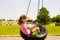 Child Swinging on a Tire Swing at the Park