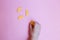 Child takes candy marmalade on a pink background. Multi-colored sweets