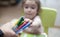 A child takes a felt-tip pen from the hands of a teacher. Child takes felt-tip pens. Hand holds felt-tip pens.