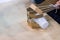 Child takes a plastic cup with a cardboard mechanical arm. STEM