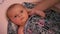 Child takes a warm bath. A newborn girl is bathed by her mother