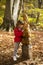 Child talking to a squirrel wooden sculpture in the