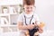 Child with teddy bear playing a doctor
