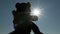 A Child with a Teddy Bear Plush Toy in Hand Reaches for the Sunlight, Sun, Sky