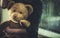 Child With Teddy Bear Sitting On Windowsill At Night