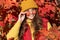 Child teen girl in autumn fall park outdoor, autumn fun kids face. cheerful teen girl in sunglasses at autumn leaves on