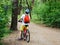 Child teenager on bicycle ride in forest at spring or summer. Happy smiling Boy cycling outdoors in blue helmet. Active lifestyle
