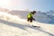 Child teenager boy skiing fast in mountains. School boy having fun running downhill slope at alpine resort during winter