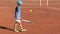 Child tennis player plays with ball and racket on court. Childrens sports and physical activity. Kids fun sport game