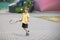 Child with a tennis racket and a ball.