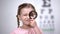 Child testing vision with magnifier, diagnosis of cornea, eyesight illness