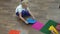 Child with therapist assembles massage mat for sensory integration lesson. Foot massage to prevent flat feet in children
