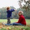 Child throwing autumn leafs