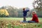 Child throwing autumn leafs