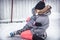 Child toddler fall in elder sisters embrace when learning ice skating on skating rink overcoming difficulties through injuries  in