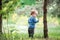 Child toddler looking to tree