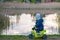 Child toddler near lake with bike looking to water