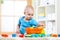 Child toddler playing wooden toys at home