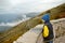 Child tourist is admiring of aerial top view of mountains range in Lovcen national park, Montenegro. Picturesque landscape