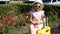 Child tourist with big yellow suitcase. Baby girl waiting for travel